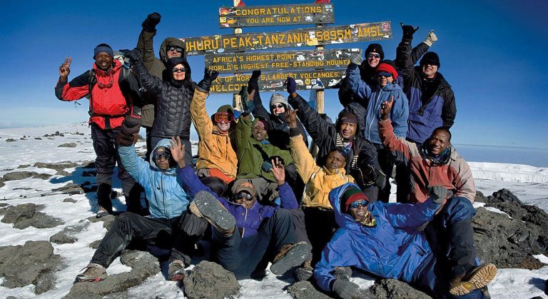 1-slide-kilimanjaro-trek-climbers-summit-pano